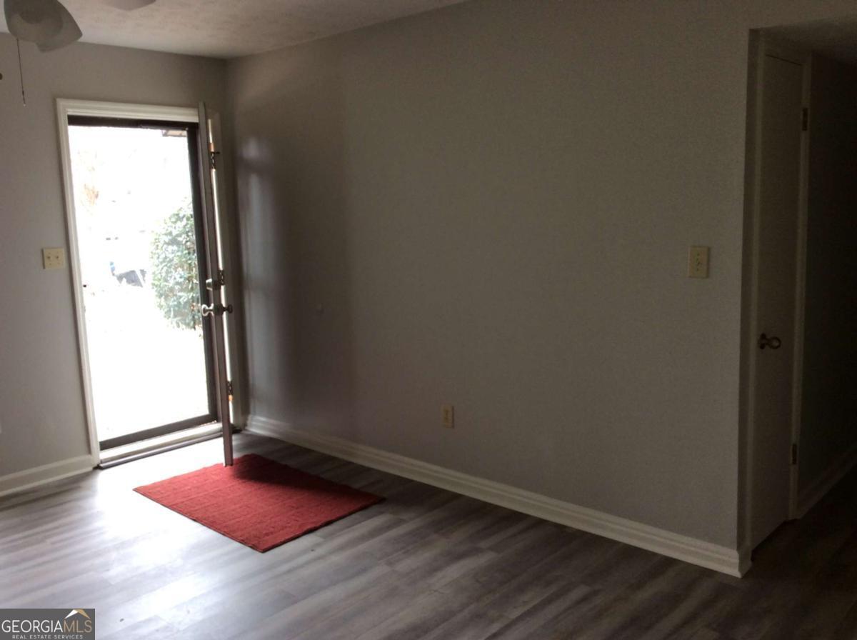 106 Richard Way Stockbridge, GA 30281 - Photo 3 of 15 an empty room with wooden floor and windows