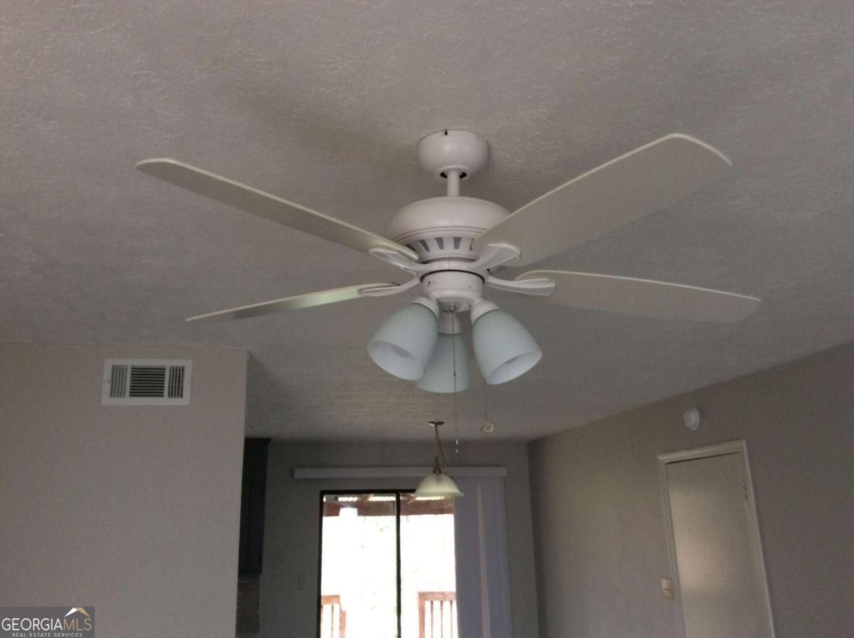 106 Richard Way Stockbridge, GA 30281 - Photo 7 of 15 a light fixture a chandelier fan and a window