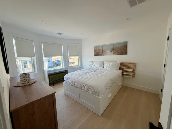 a bedroom with a bed a couch and dresser