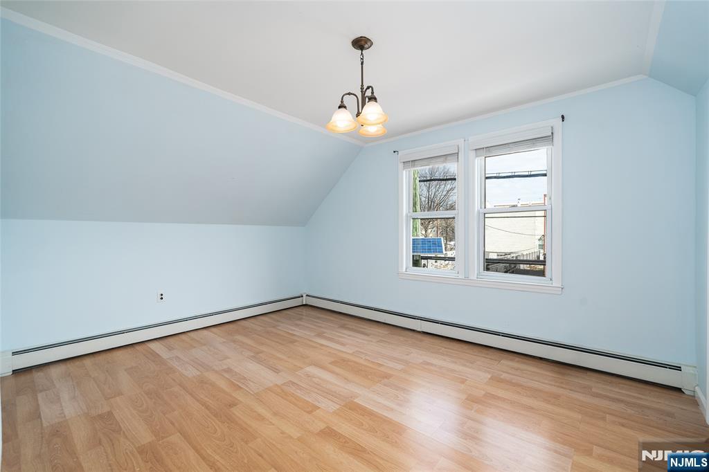 46 East 16th Street Bayonne, NJ 07002 - Photo 15 of 24 an empty room with wooden floor chandelier fan and windows