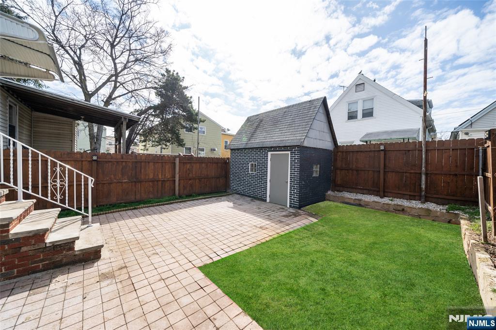 46 East 16th Street Bayonne, NJ 07002 - Photo 20 of 24 a view of house with backyard and a garden