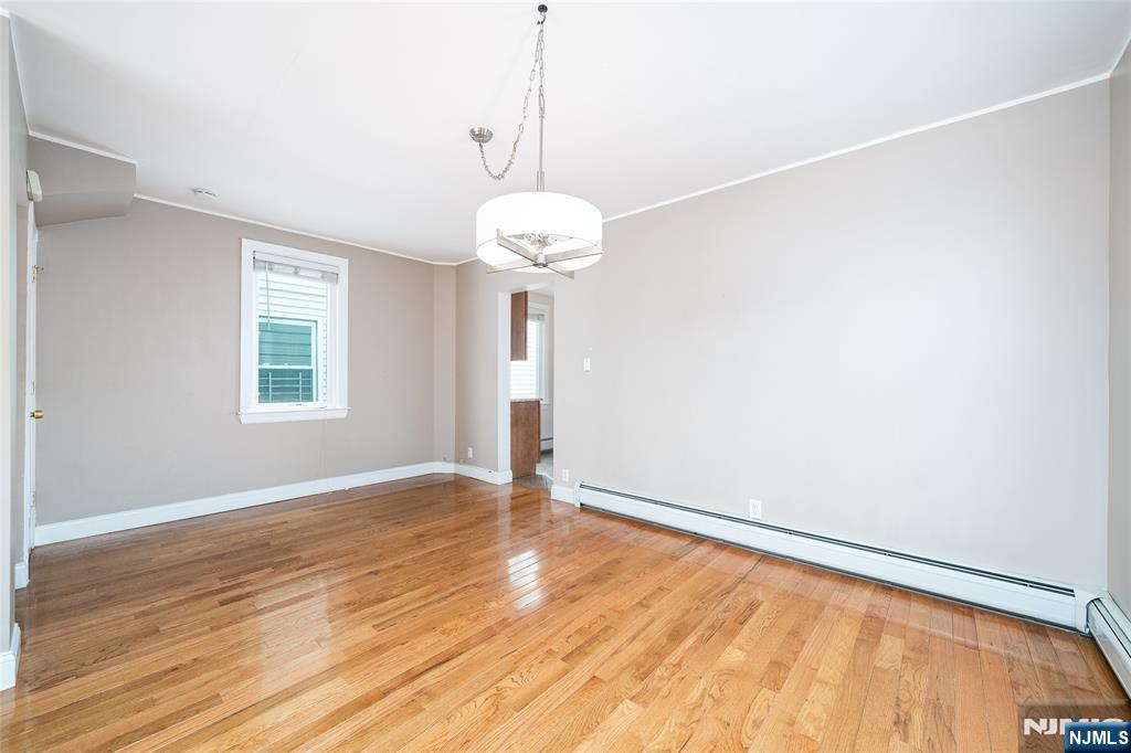 46 East 16th Street Bayonne, NJ 07002 - Photo 9 of 24 a view of an empty room with wooden floor and a window