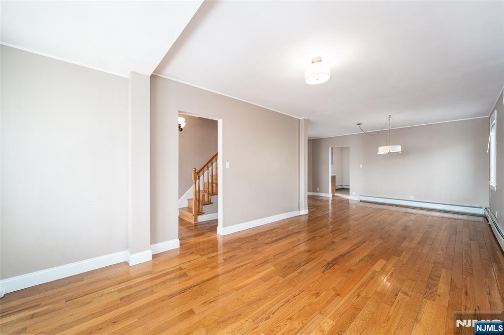 46 East 16th Street Bayonne, NJ 07002 - Photo 10 of 24 a view of empty room with wooden floor and fan