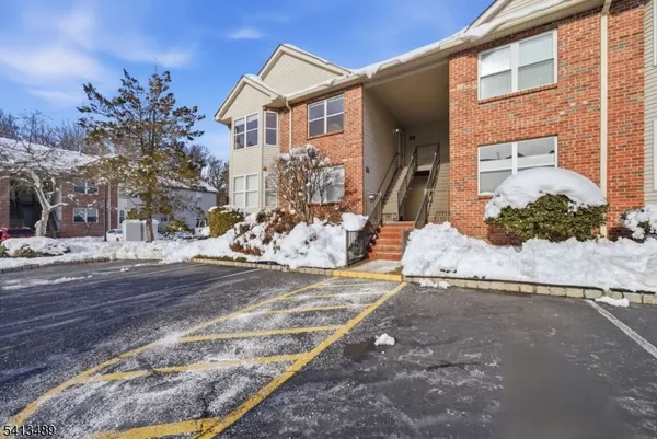 a view of a house with a snow on the road
