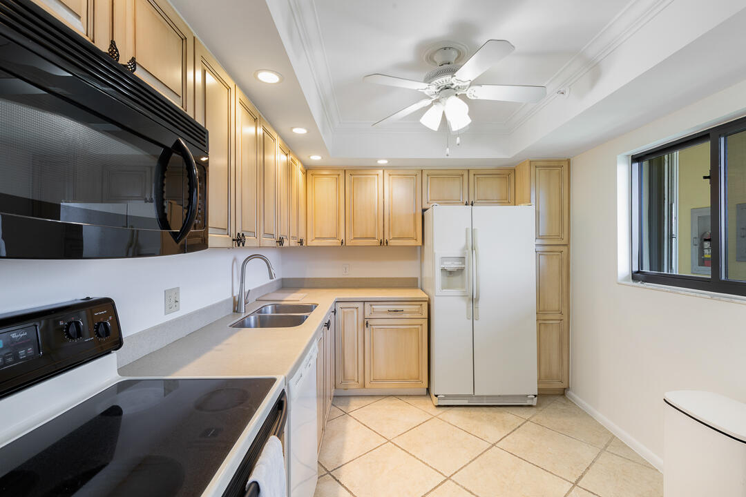 400 Ocean Trail Way, Unit 1108 Jupiter, FL 33477 - Photo 14 of 41 a kitchen with a refrigerator a sink and dishwasher