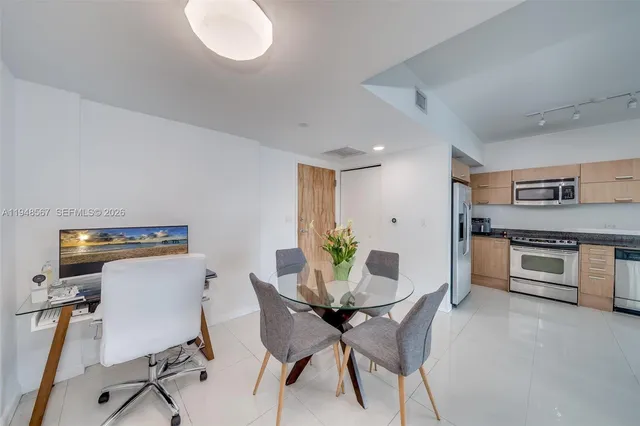 a view of a dining room with furniture and a potted plant