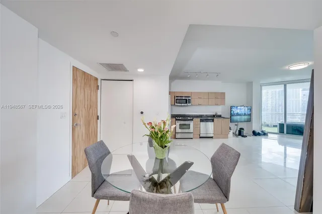 a living room with furniture a dining table and chairs