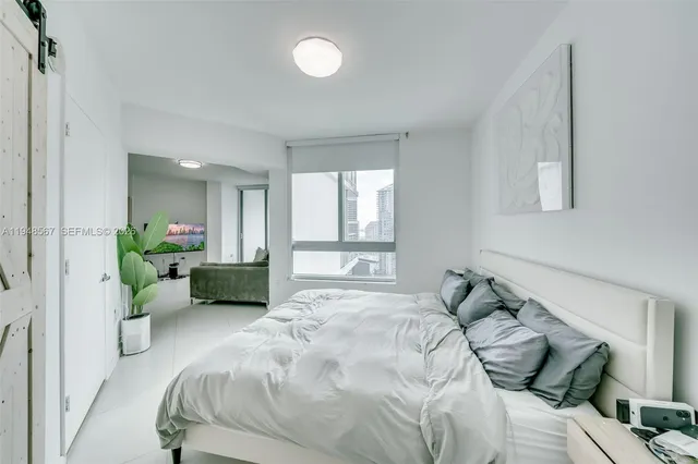 a bedroom with bed and a couch