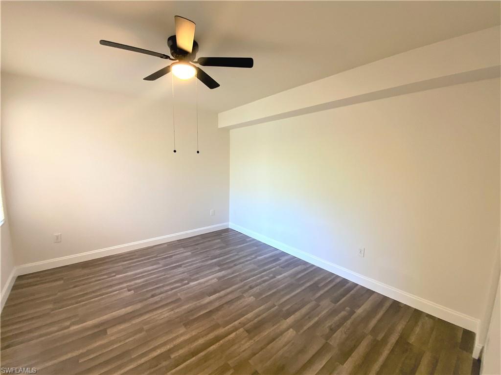7960 Preserve Circle, Unit 616 Naples, FL 34119 - Photo 11 of 20 a view of empty room with wooden floor
