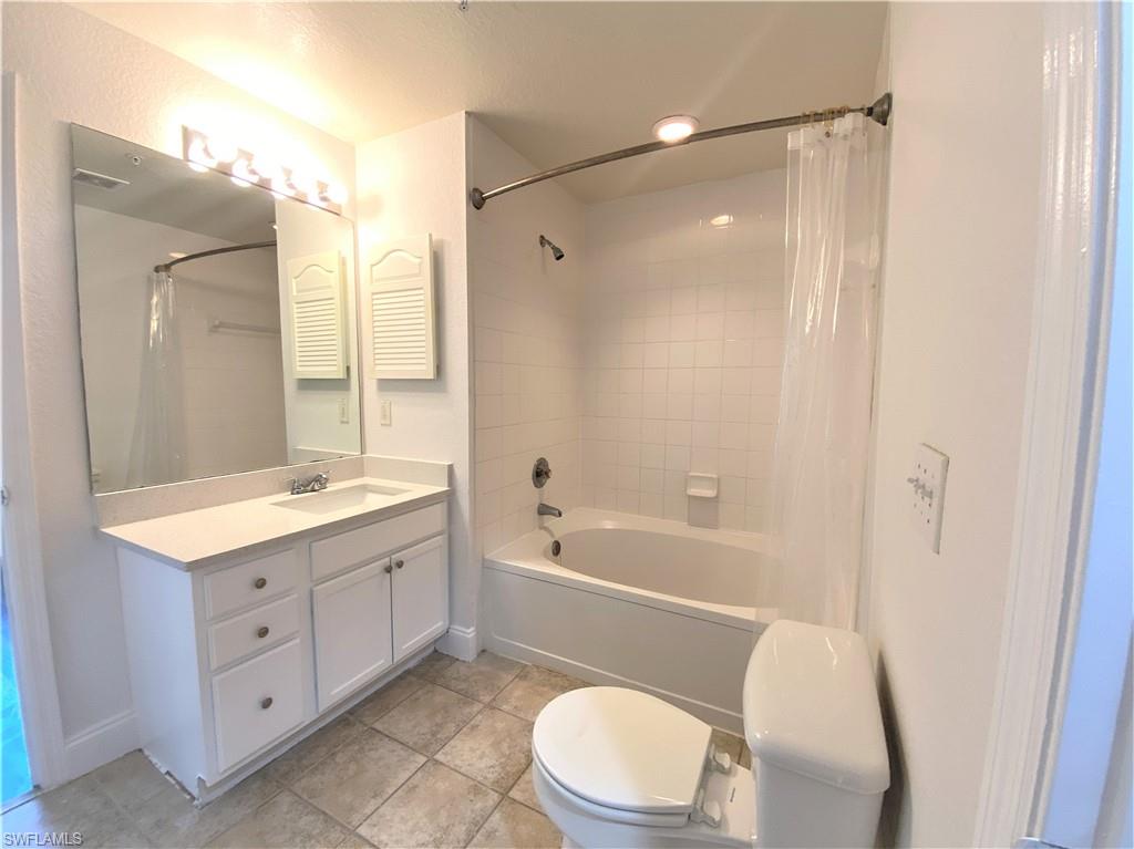 7960 Preserve Circle, Unit 616 Naples, FL 34119 - Photo 14 of 20 a bathroom with a granite countertop sink toilet a shower and a mirror