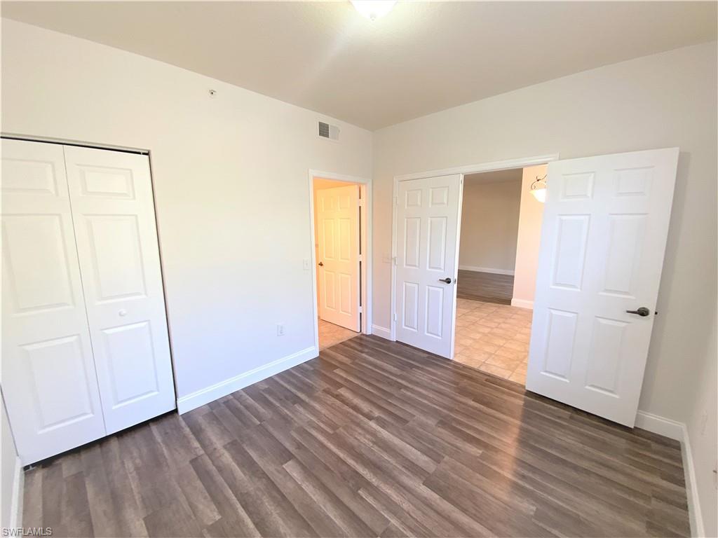 7960 Preserve Circle, Unit 616 Naples, FL 34119 - Photo 16 of 20 a view of empty room with wooden floor