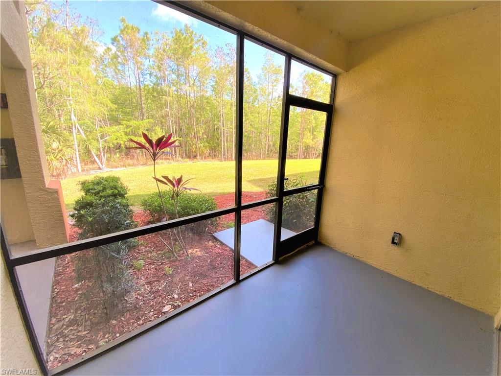7960 Preserve Circle, Unit 616 Naples, FL 34119 - Photo 19 of 20 a view of a room with wooden floor and windows