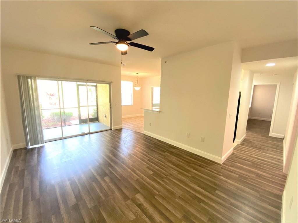 7960 Preserve Circle, Unit 616 Naples, FL 34119 - Photo 2 of 20 a view of an empty room with wooden floor and a window