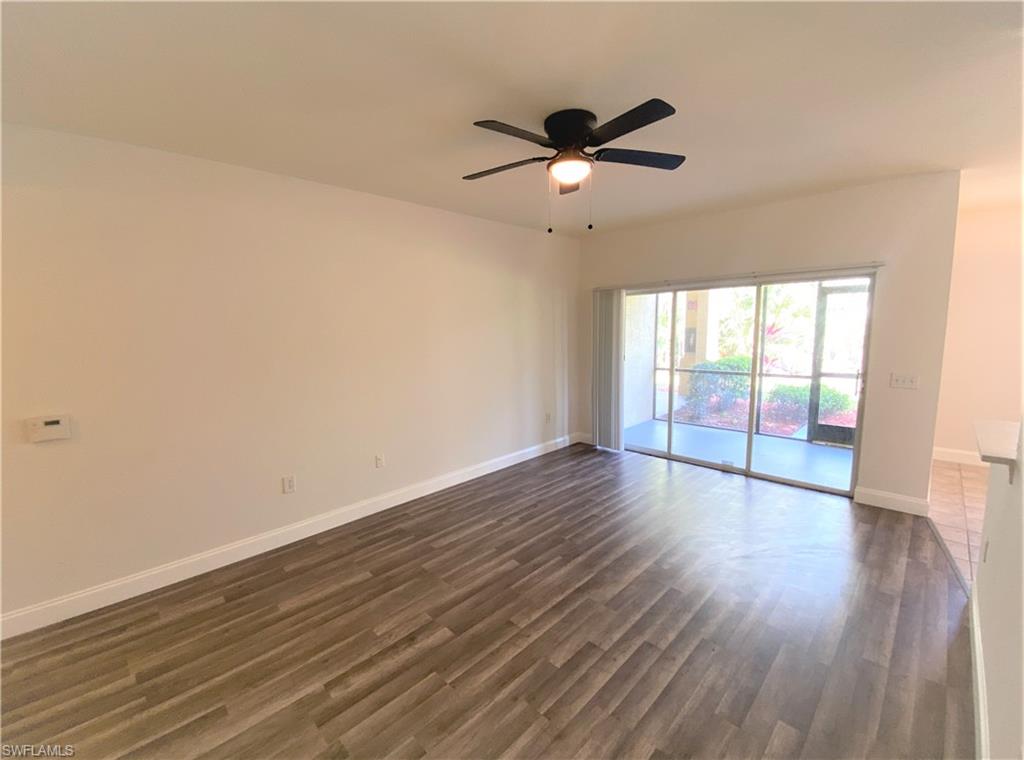 7960 Preserve Circle, Unit 616 Naples, FL 34119 - Photo 5 of 20 a view of an empty room with wooden floor and a window