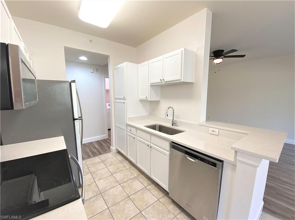7960 Preserve Circle, Unit 616 Naples, FL 34119 - Photo 10 of 20 a kitchen with a sink stove and refrigerator