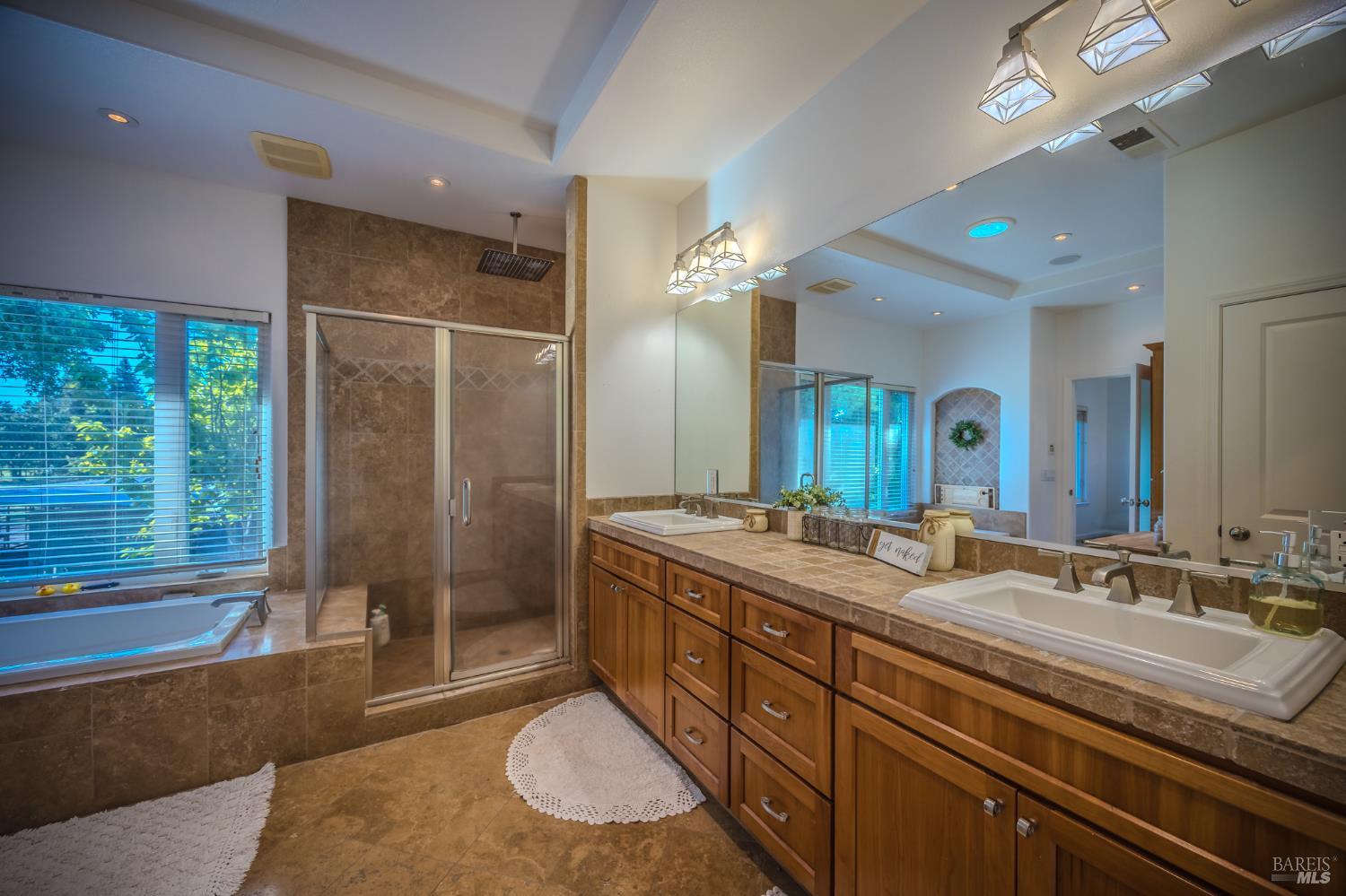4100 Bisordi Lane Fulton, CA 95439 - Photo 73 of 77 a spacious bathroom with a granite countertop sink a toilet a mirror and shower