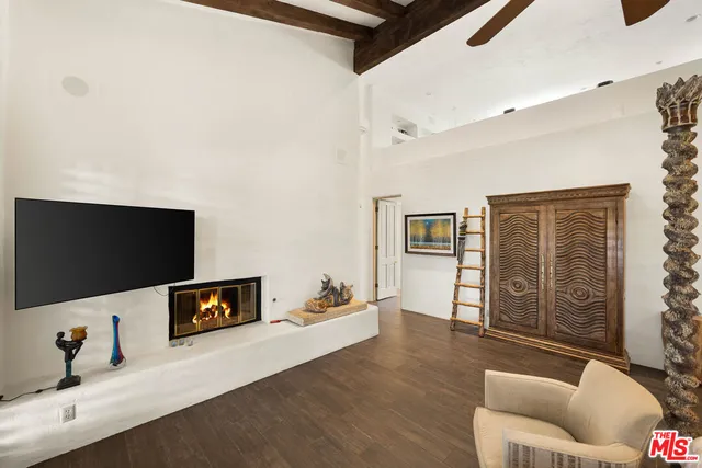 a bathroom with a large tub a sink and glass windows