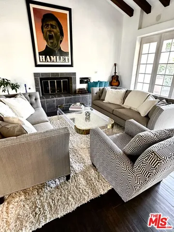 a living room with fireplace furniture and a floor to ceiling window
