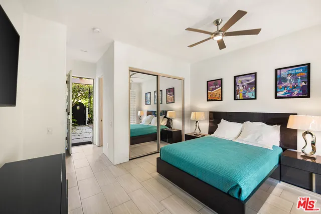 a bedroom with a bed and a flat screen tv