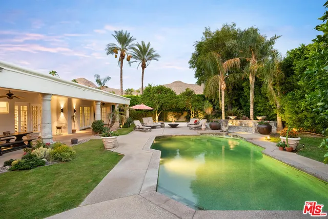 a front view of house with yard and outdoor seating