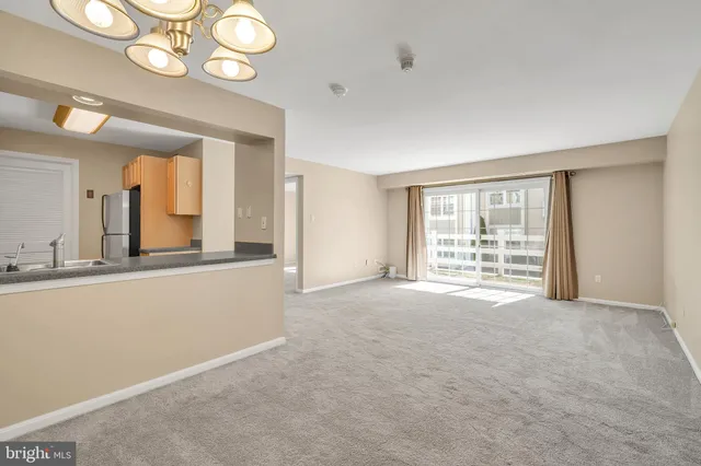 a view of an empty room with a fireplace and a large window