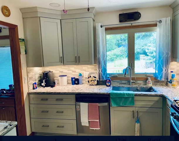 a kitchen with sink cabinets and window
