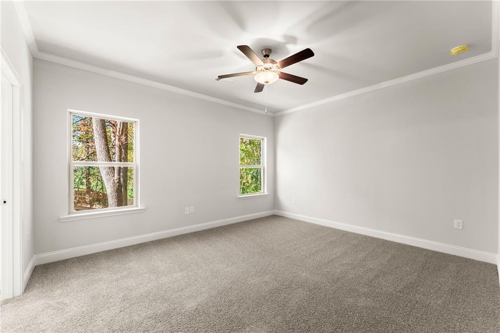 661 Forest Way Cornelia, GA 30531 - Photo 17 of 45 an empty room with windows and fan