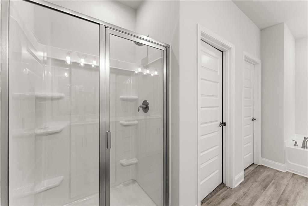 661 Forest Way Cornelia, GA 30531 - Photo 22 of 45 a bathroom with a glass shower door