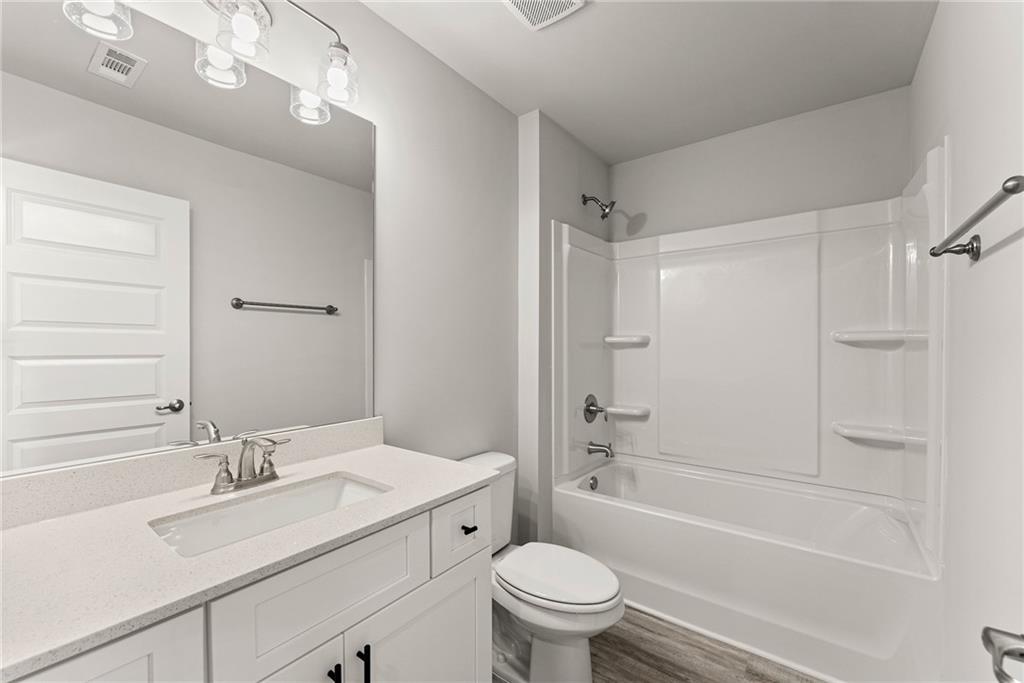 661 Forest Way Cornelia, GA 30531 - Photo 38 of 45 a bathroom with a sink a toilet and shower