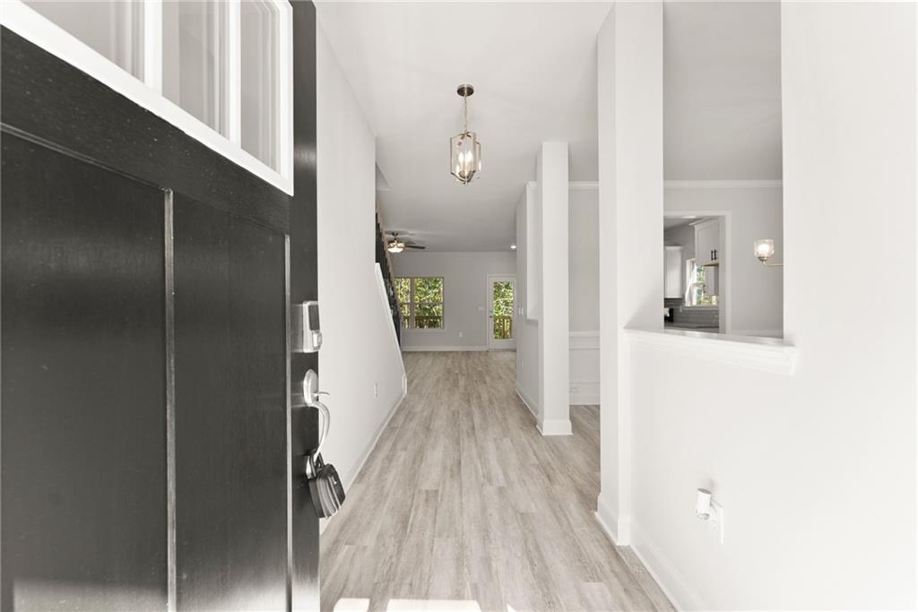 661 Forest Way Cornelia, GA 30531 - Photo 5 of 45 a view of a hallway with wooden floor and staircase