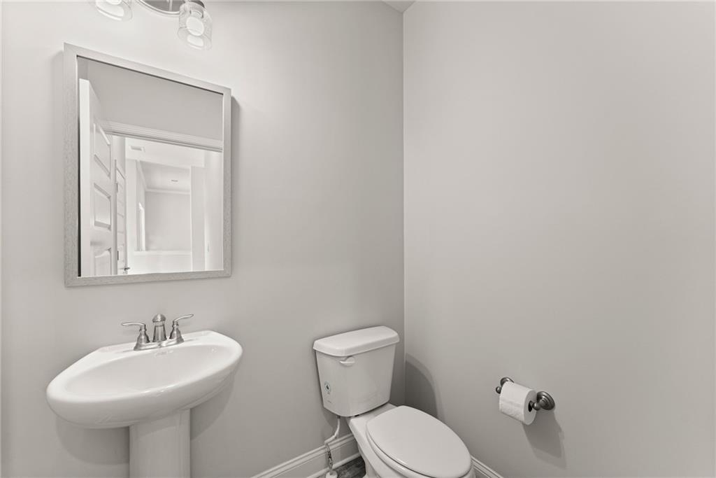 661 Forest Way Cornelia, GA 30531 - Photo 6 of 45 a bathroom with a toilet sink and mirror