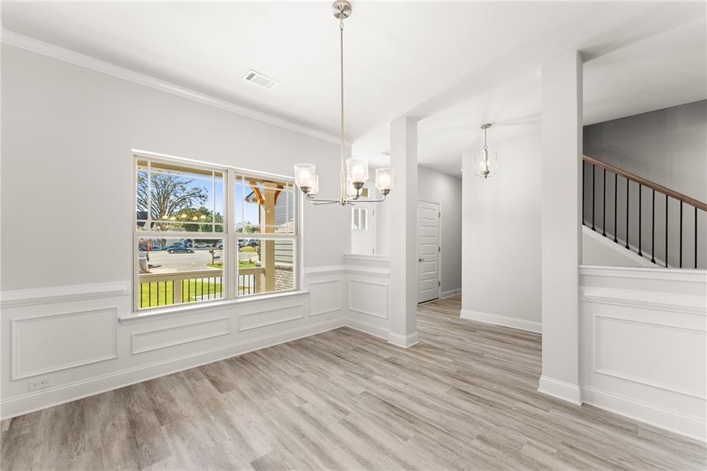 661 Forest Way Cornelia, GA 30531 - Photo 8 of 45 a view of an empty room with wooden floor and a window