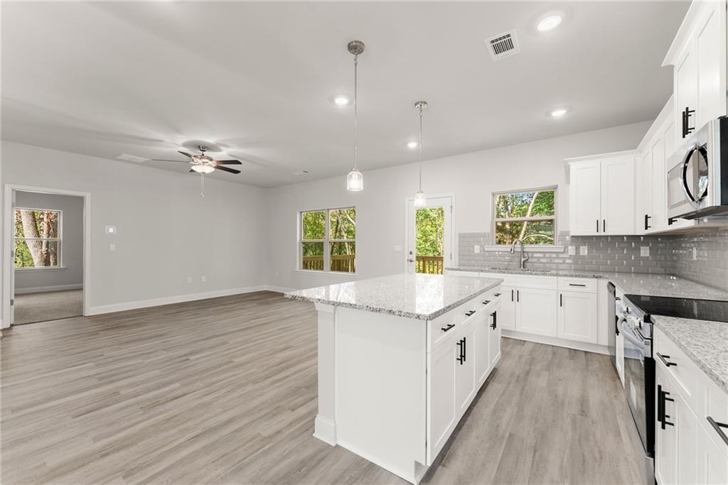 661 Forest Way Cornelia, GA 30531 - Photo 9 of 45 a kitchen with a sink and wooden floor