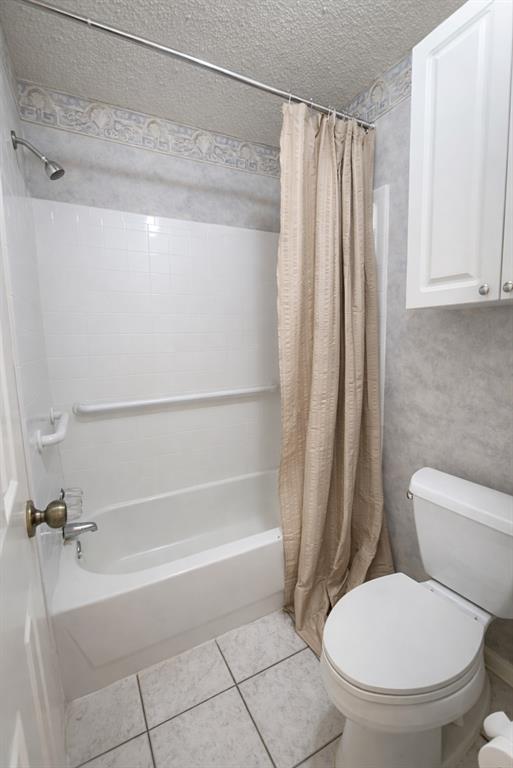 2302 Shiloh Street Denison, TX 75020 - Photo 14 of 16 a bathroom with a toilet and a shower