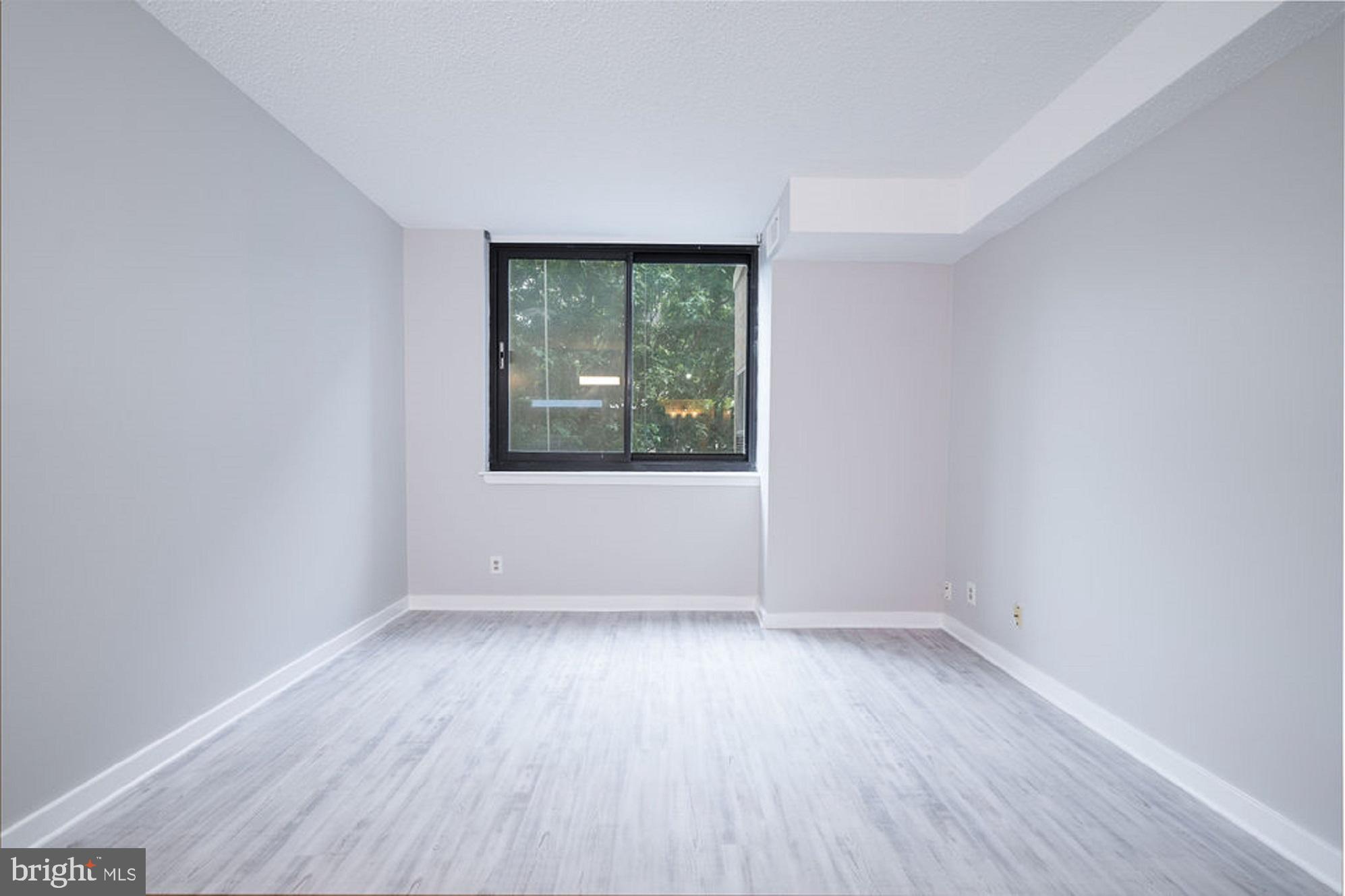 5505 Seminary Road, Unit 103N Falls Church, VA 22041 - Photo 19 of 59 an empty room with wooden floor and windows
