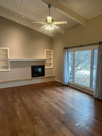 a bathroom with a double vanity sink and mirror with window