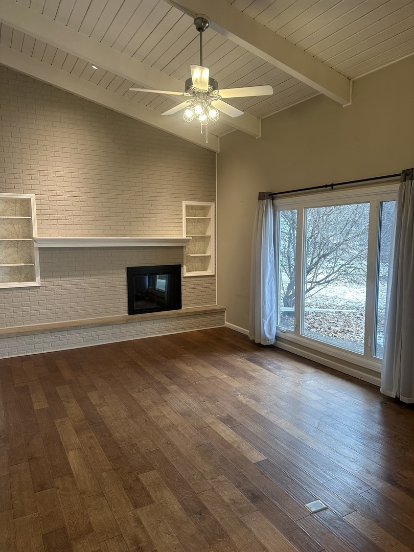2211 Benjamin Lane Bloomington, IL 61701 - Photo 12 of 50 an empty room with wooden floor and windows