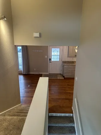 an empty room with wooden floor and closet area