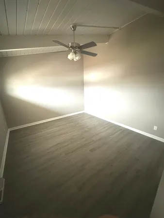 a view of a garage with wooden deck