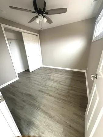 a view of a yard with wooden fence