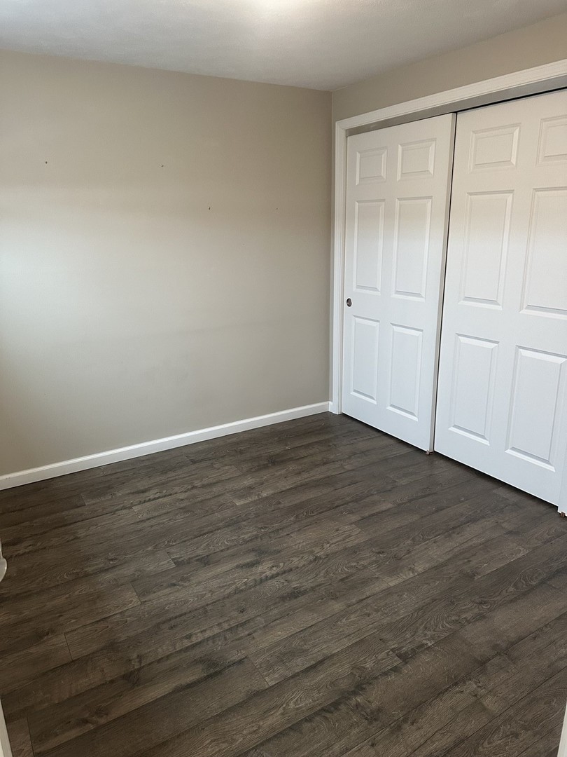 2211 Benjamin Lane Bloomington, IL 61701 - Photo 36 of 50 a view of an empty room with wooden floor