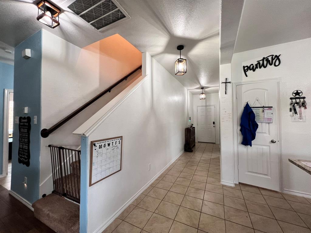 324 Fairgrounds Lane Ponder, TX 76259 - Photo 29 of 40 a view of a hallway with entryway and chandelier