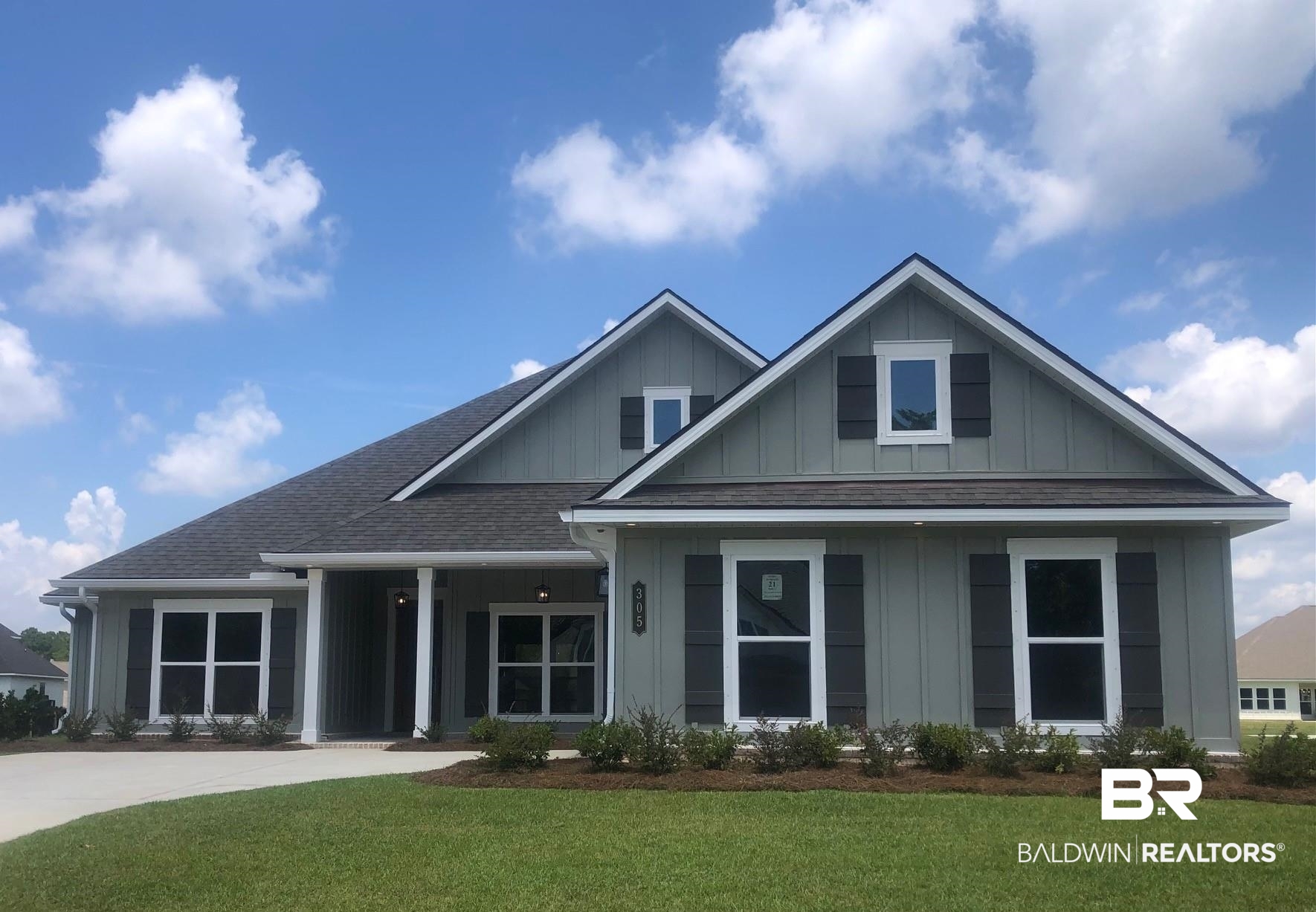 305 Morning Mist Way Fairhope, AL 36532 - Photo 1 of 66 View of front of home with board and batten siding, a front yard, and a shingled roof