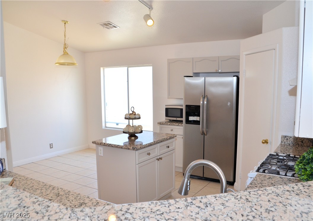 7340 Alpine Ridge Street Las Vegas, NV 89131 - Photo 8 of 36 View from living room into the kitchen.