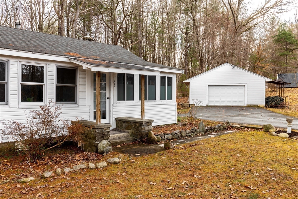 85 Colonial Drive Littleton, MA 01460 - Photo 17 of 26 a front view of a house with a yard