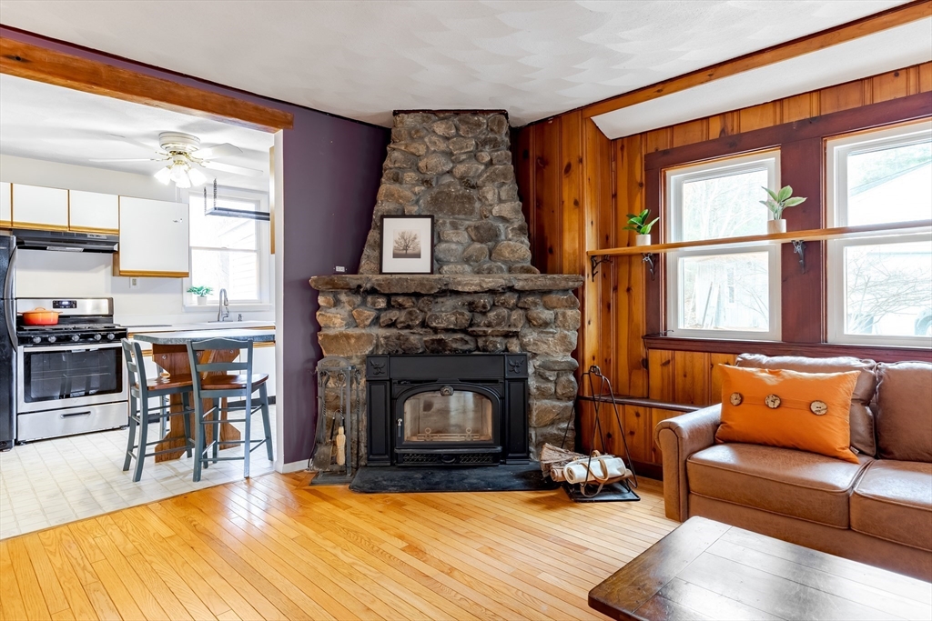 85 Colonial Drive Littleton, MA 01460 - Photo 3 of 26 a living room with furniture wooden floor and a fireplace