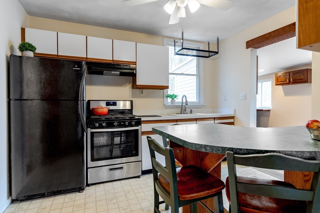 85 Colonial Drive Littleton, MA 01460 - Photo 6 of 26 a kitchen with stainless steel appliances granite countertop a stove a refrigerator and a sink