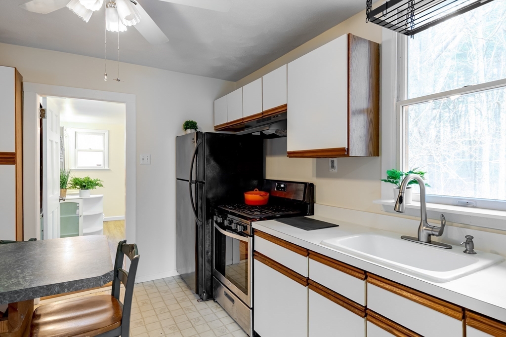 85 Colonial Drive Littleton, MA 01460 - Photo 7 of 26 a kitchen with stainless steel appliances a sink cabinets and a window