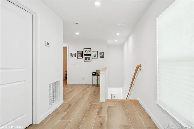 a view of a room with wooden floor and window