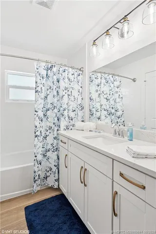 a bathroom with a sink a mirror and shower